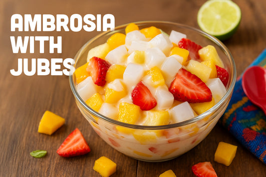 Bowl of Ensalada de Fruta with Jubes nata de coco cubes, mango, strawberries, and pineapple on a wooden table.