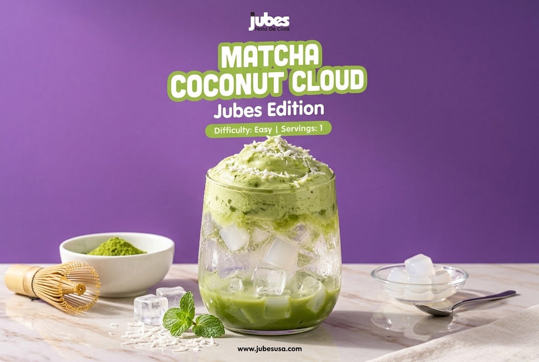 A layered Matcha Coconut Cloud drink with Jubes coconut jelly cubes, ice, and matcha foam, beside a matcha bowl, whisk, and mint.