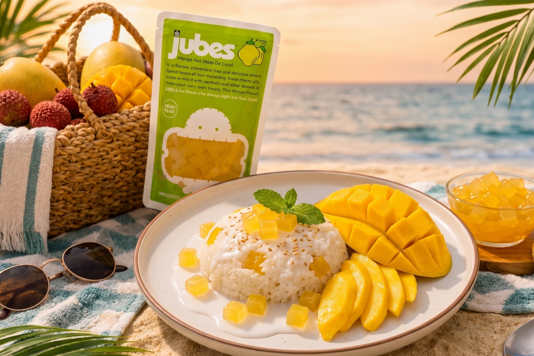 Plate of mango sticky rice topped with ripe mango slices, creamy coconut sauce, and golden Jubes mango nata de coco jelly cubes, styled as a tropical dessert