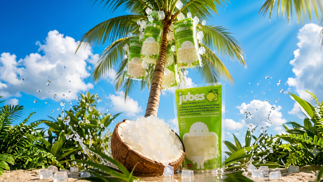 A bag of Jubes coconut jelly sits on a sunny beach next to a coconut shell filled with translucent jelly cubes under a palm tree.