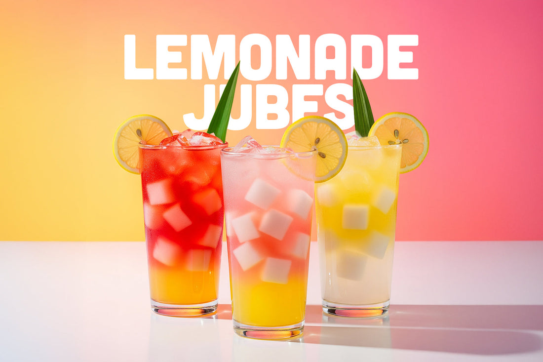 Three tall glasses of colorful lemonade with Jubes coconut gel cubes, garnished with lime slices, against a pink gradient.
