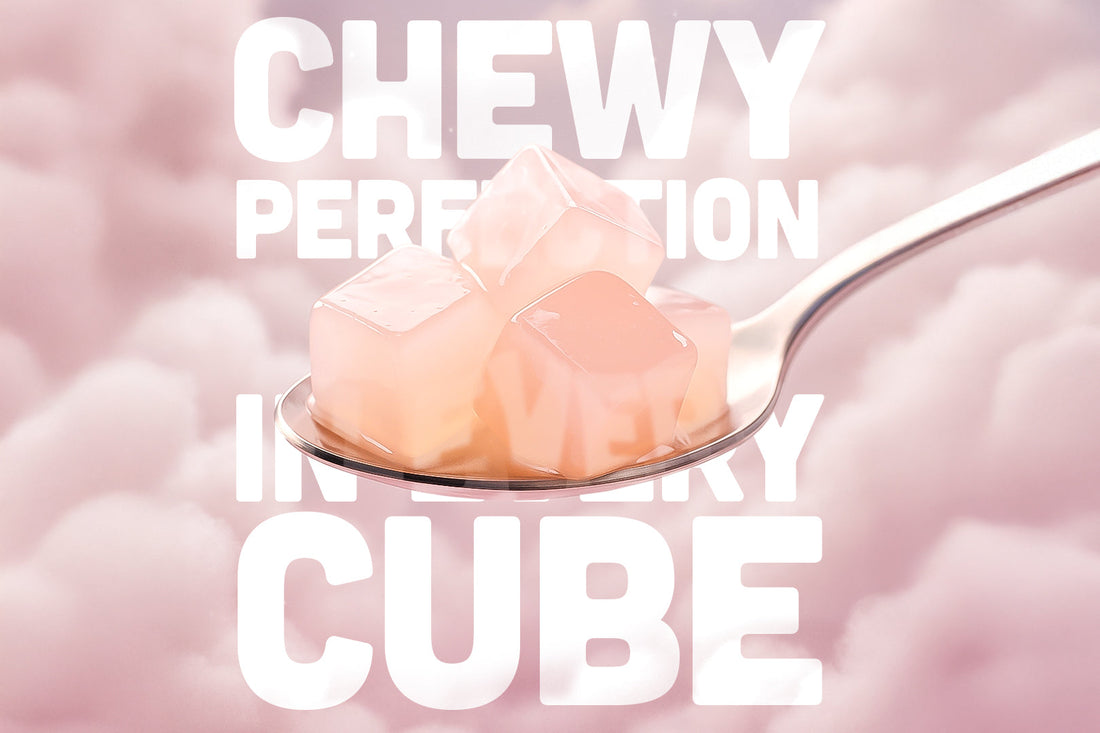 A silver spoon holding translucent pink nata de coco cubes, set against a soft cloudy pink background with bold white text reading 'CHEWY PERFECTION IN EVERY CUBE'.