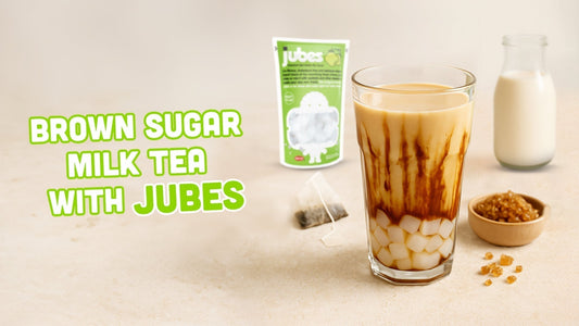 Brown sugar milk tea with caramel streaks and Jubes cubes, shown with Jubes pack, milk bottle, tea bags, and brown sugar.