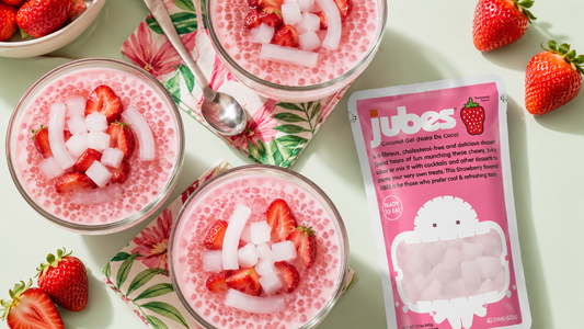 Three bowls of pink strawberry sago dessert with jelly next to a pink pouch of Jubes Coconut Gel