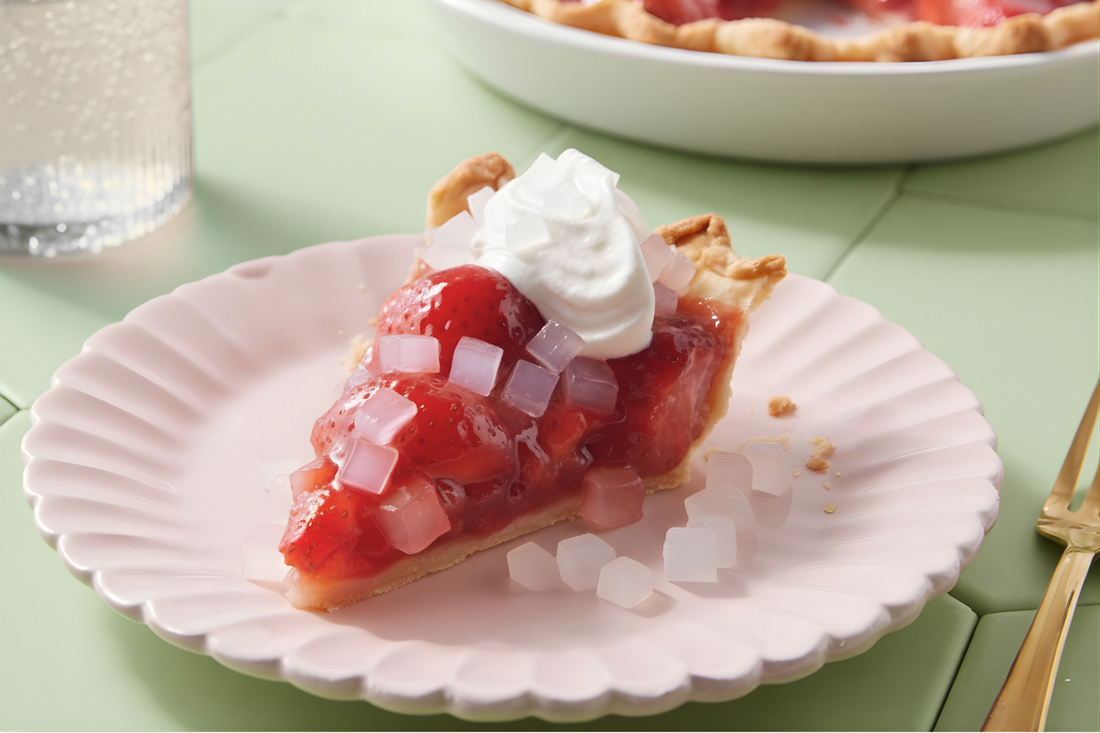 Slice of strawberry pie topped with whipped cream and nata de coco cubes.