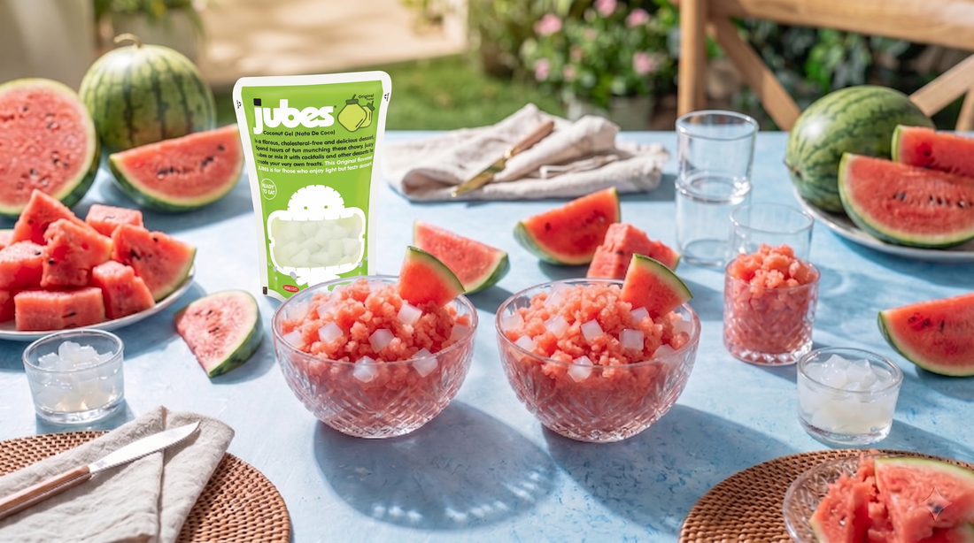 Refreshing watermelon granita topped with chewy Jubes nata de coco coconut jelly cubes served in a glass with fresh mint for a tropical summer dessert.