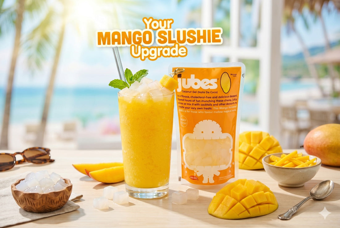 Glass of mango slushie with Pouch of Jubes Mango next to it